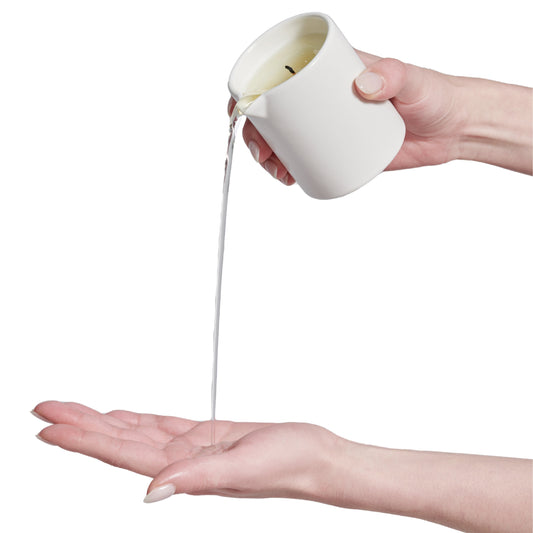 Massage candle pouring on hand