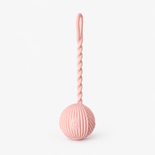 Lærke Bagger x PEECH pink yarn mini vibrator on a pale grey background